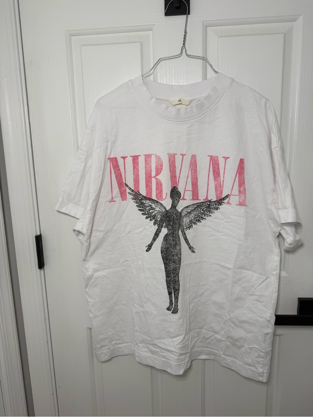 H&M White Short-Sleeve Tee with Pink 'NIRVANA' Logo and Black Angel Graphic